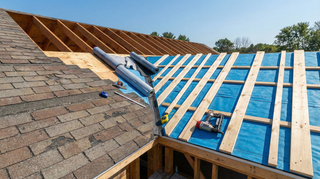 Metal roofing installed over existing asphalt shingles using underlayment and battens to improve ventilation and reduce moisture risk.