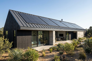 Modern standing seam metal roof featuring integrated solar panels installed with non-penetrating S-5 clamps for 2026 energy efficiency.